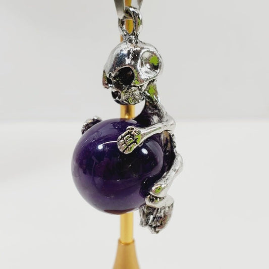 Unique Skeleton Hugging an Amethyst Ball Pendant - Unique Collectibles